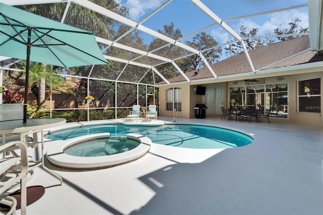 view of swimming pool with a patio area, a lanai, and a pool with connected hot tub