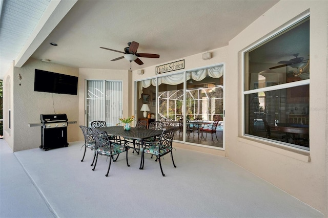 view of patio / terrace with grilling area, outdoor dining space, and a ceiling fan