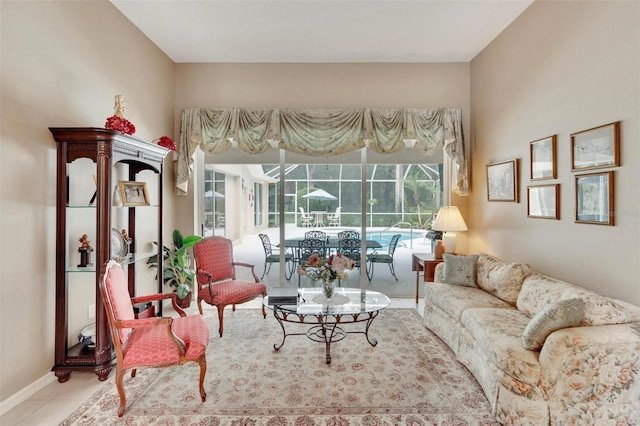 living room with tile patterned flooring, baseboards, and a sunroom