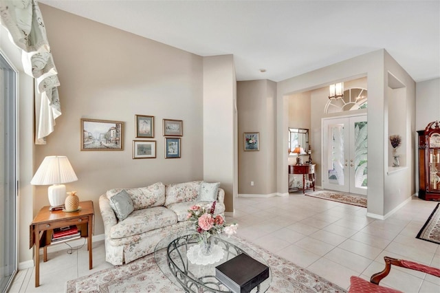 tiled living area with french doors, baseboards, and an inviting chandelier