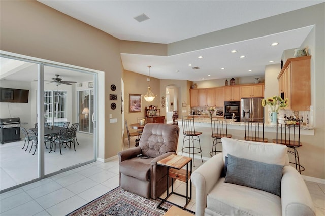 living room featuring light tile patterned flooring, recessed lighting, arched walkways, and baseboards