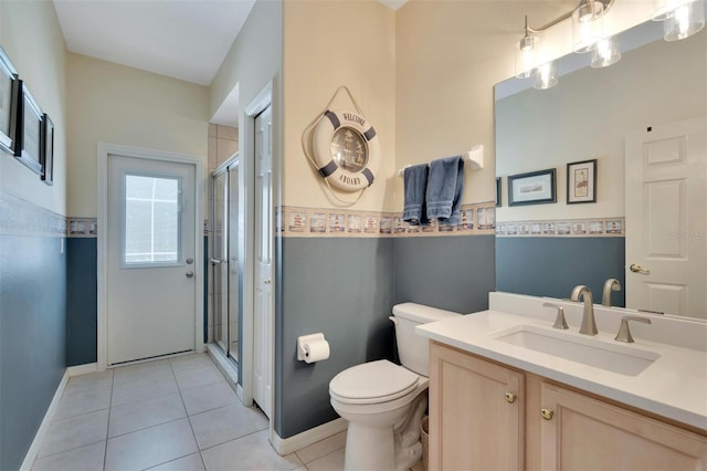 full bath with tile patterned flooring, toilet, vanity, and a stall shower