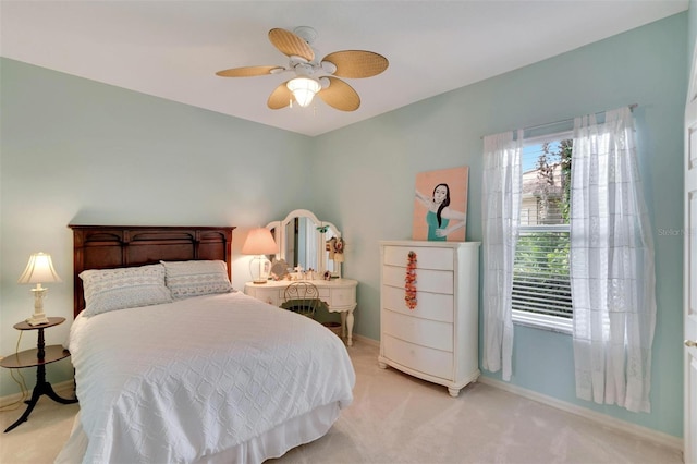 bedroom with baseboards, light carpet, and ceiling fan