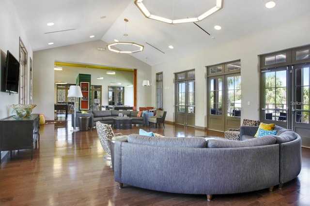 living area featuring wood finished floors, recessed lighting, french doors, and high vaulted ceiling