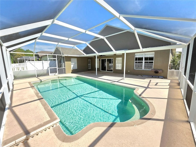 view of pool with a patio, a fenced in pool, fence, and a lanai