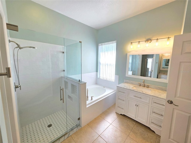 full bathroom with tile patterned flooring, a stall shower, vanity, and a bath