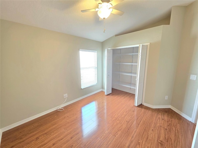 unfurnished bedroom with a closet, baseboards, light wood-style flooring, and a ceiling fan