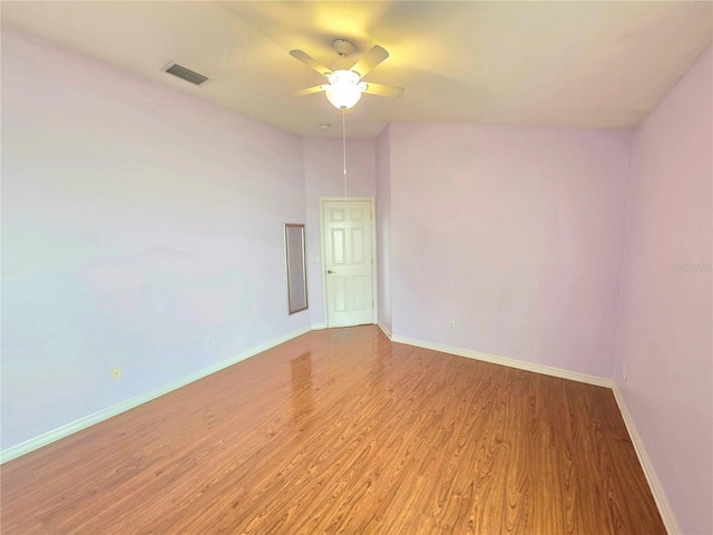 spare room with visible vents, baseboards, ceiling fan, and light wood finished floors