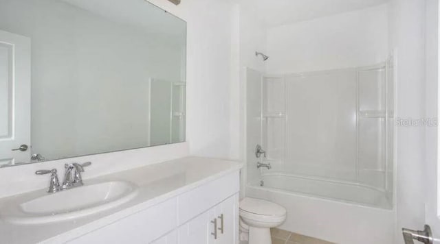 bathroom with tile patterned floors, shower / washtub combination, toilet, and vanity