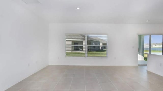 tiled spare room with recessed lighting