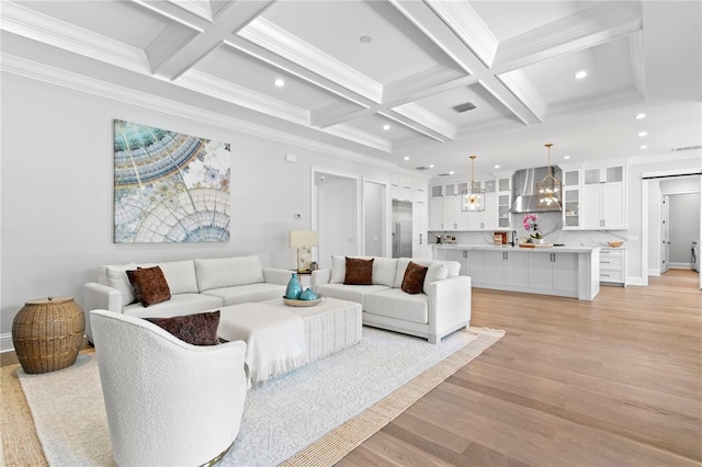 living room with beamed ceiling, recessed lighting, light wood finished floors, and ornamental molding