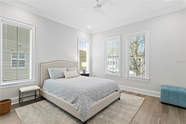 bedroom with multiple windows, baseboards, and ornamental molding