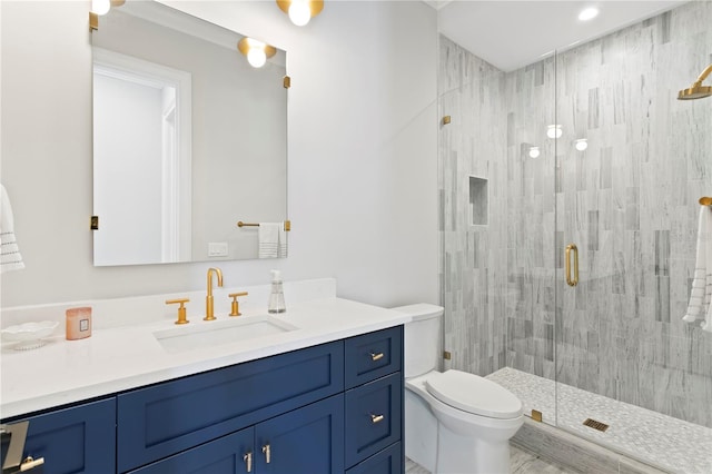 bathroom with a shower stall, toilet, and vanity