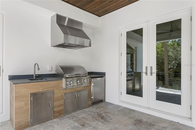 view of patio / terrace featuring a sink, french doors, area for grilling, and exterior kitchen