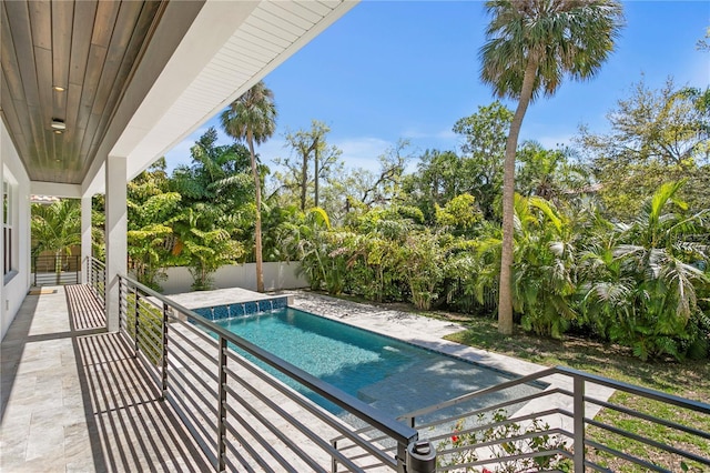 view of swimming pool with a patio area, a fenced in pool, and fence