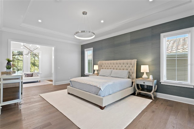 bedroom featuring crown molding, multiple windows, and baseboards