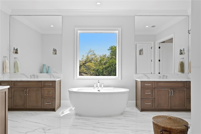 bathroom with a sink, marble finish floor, a freestanding bath, and two vanities