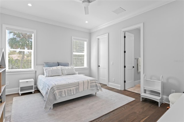 bedroom featuring visible vents, baseboards, and wood finished floors