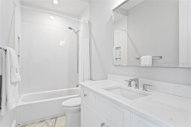 full bathroom featuring vanity, toilet, marble finish floor, and bathing tub / shower combination