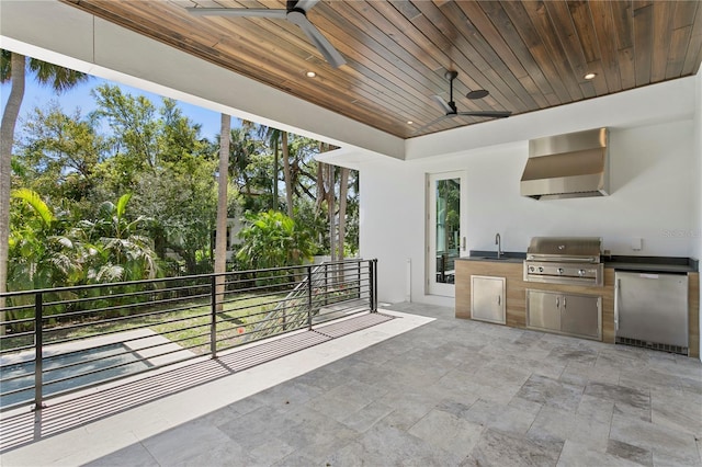 view of patio / terrace featuring ceiling fan, exterior kitchen, a balcony, and grilling area