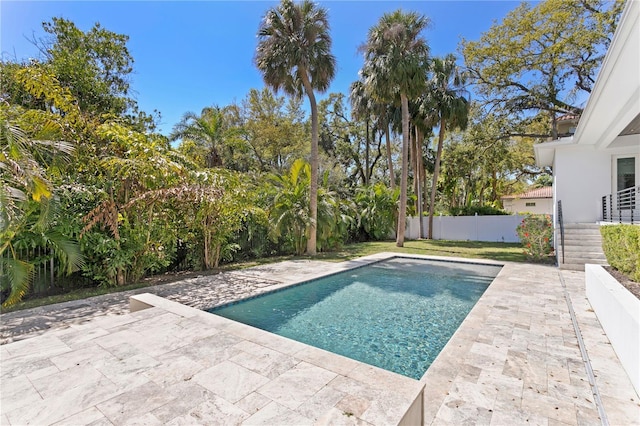 view of pool featuring a patio, a fenced backyard, and a fenced in pool