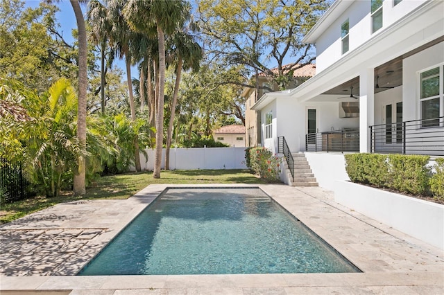 view of swimming pool with a fenced in pool, a fenced backyard, a ceiling fan, and a patio area