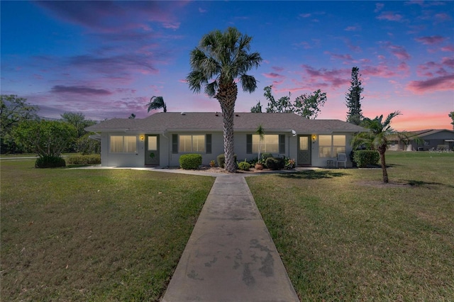 view of front of house with a yard