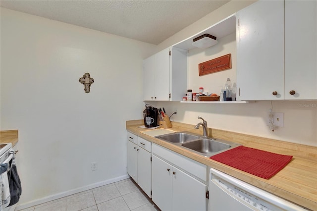 kitchen with a sink, light countertops, white appliances, and white cabinetry