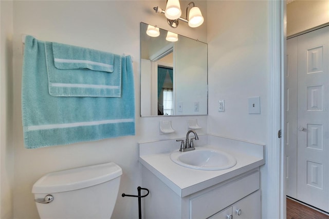 half bathroom featuring toilet and vanity