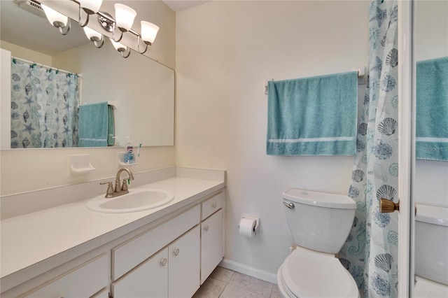 bathroom with toilet, tile patterned floors, baseboards, and vanity