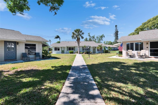 view of front of house with a patio and a front yard