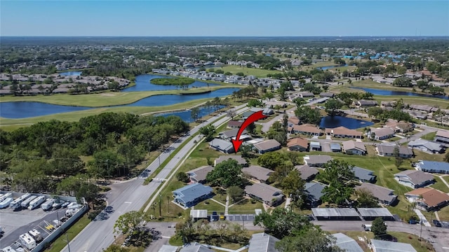 bird's eye view with a residential view, a water view, and golf course view