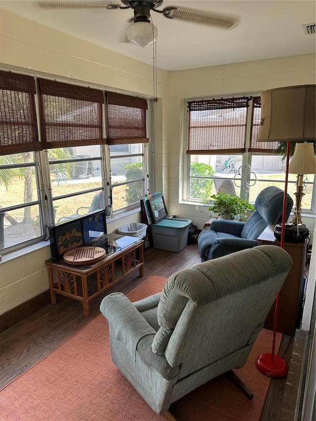 living room featuring visible vents, ceiling fan, and wood finished floors