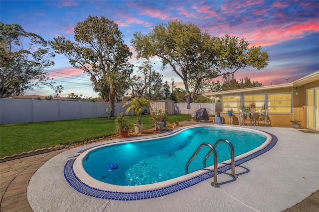 view of pool with a fenced backyard, a patio area, a yard, and a fenced in pool