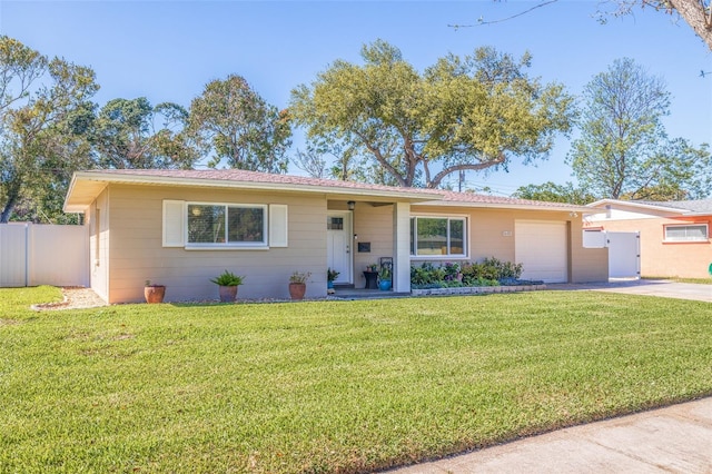 ranch-style house with a garage, a front yard, driveway, and fence