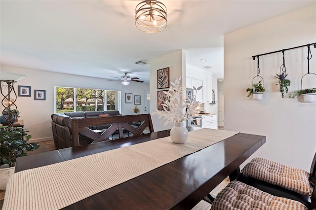 dining area with visible vents, baseboards, ceiling fan, and wood finished floors