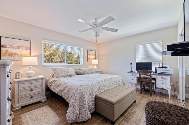 bedroom featuring ceiling fan, baseboards, and wood finished floors