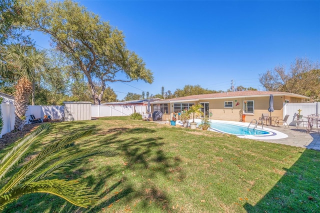 view of yard with a patio area, a fenced backyard, and a fenced in pool