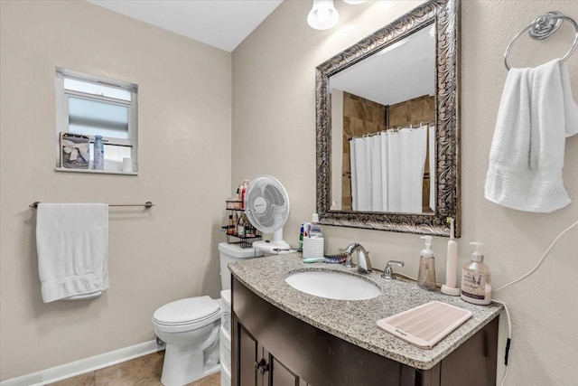 bathroom with vanity, curtained shower, and toilet