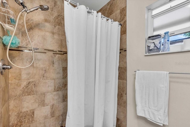 full bath with a tile shower