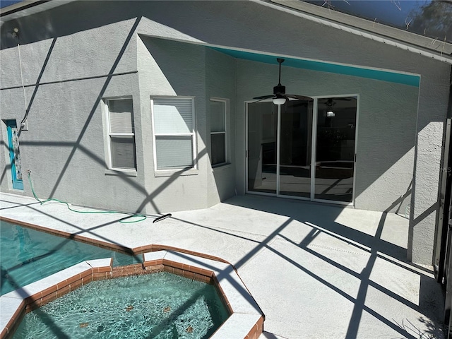 view of patio / terrace featuring an in ground hot tub and ceiling fan