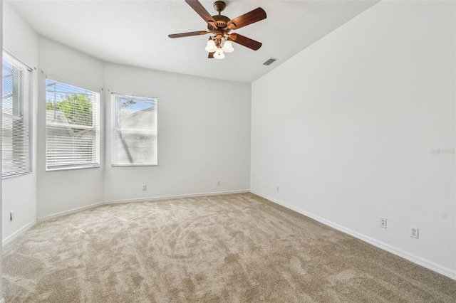 unfurnished room with baseboards, visible vents, carpet floors, and ceiling fan