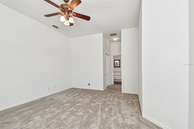 spare room featuring visible vents, ceiling fan, baseboards, and carpet