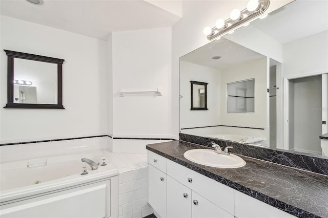 full bath with vanity and a whirlpool tub