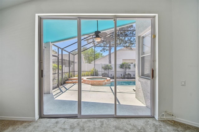 entryway featuring baseboards, a ceiling fan, carpet flooring, and a sunroom