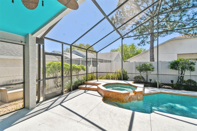 view of pool with a patio area, an in ground hot tub, a lanai, and fence