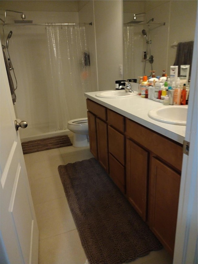 bathroom featuring a sink, a stall shower, and tile patterned floors