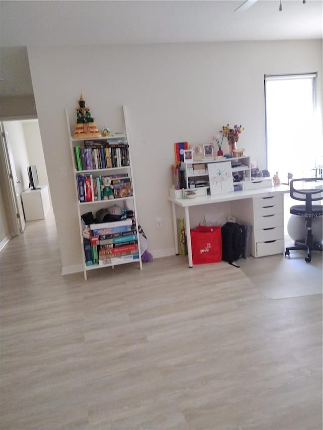 office space featuring baseboards and wood finished floors