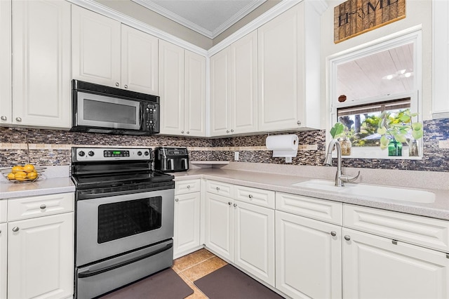 kitchen with stainless steel range with electric stovetop, a sink, tasteful backsplash, white cabinets, and crown molding