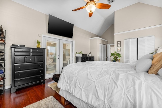 bedroom featuring two closets, ceiling fan, vaulted ceiling, french doors, and wood finished floors